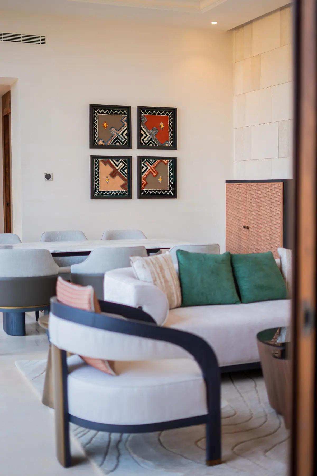 An armchair beneath framed artwork