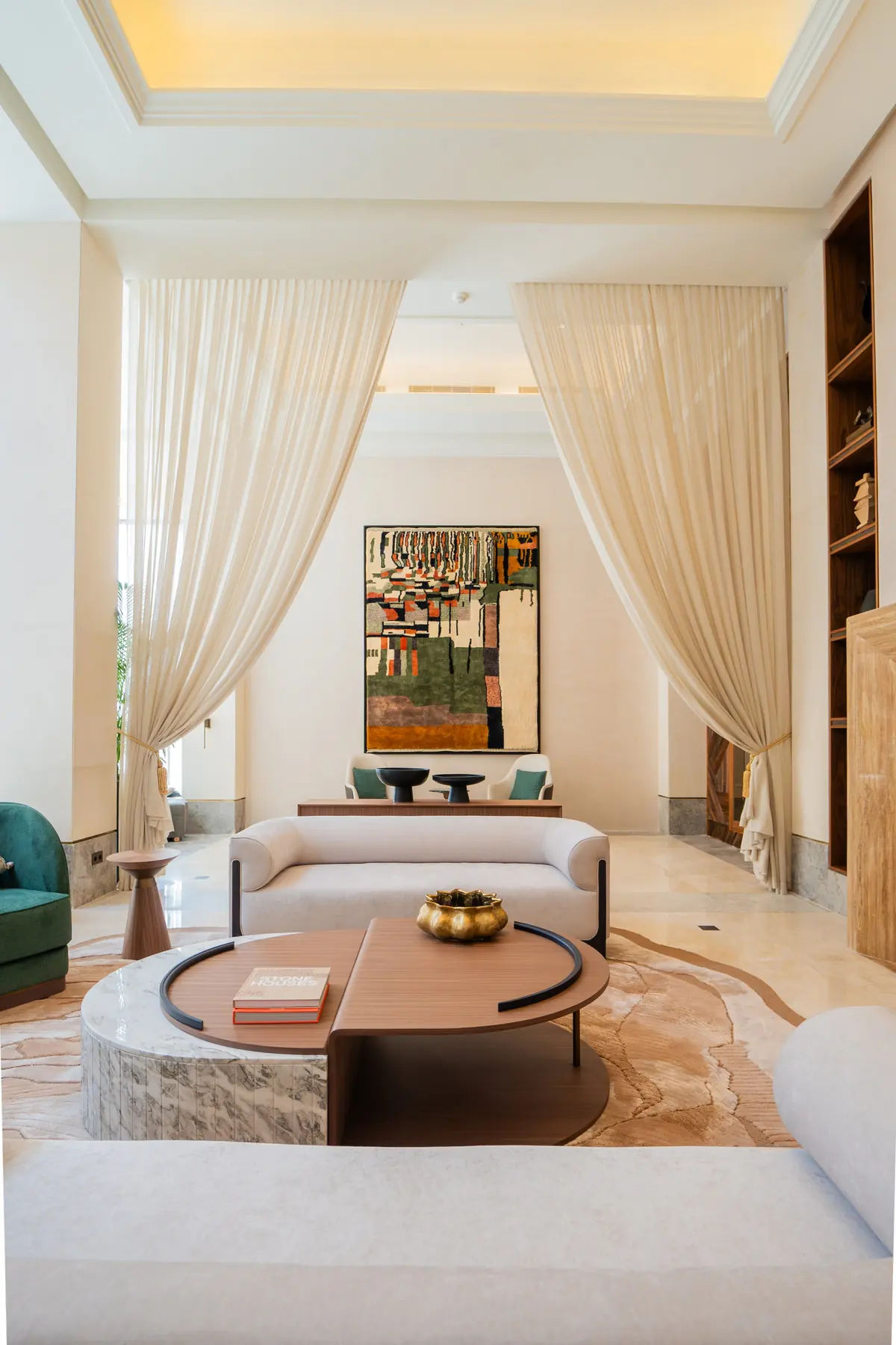 A lounge framed by drapes and a large artwork