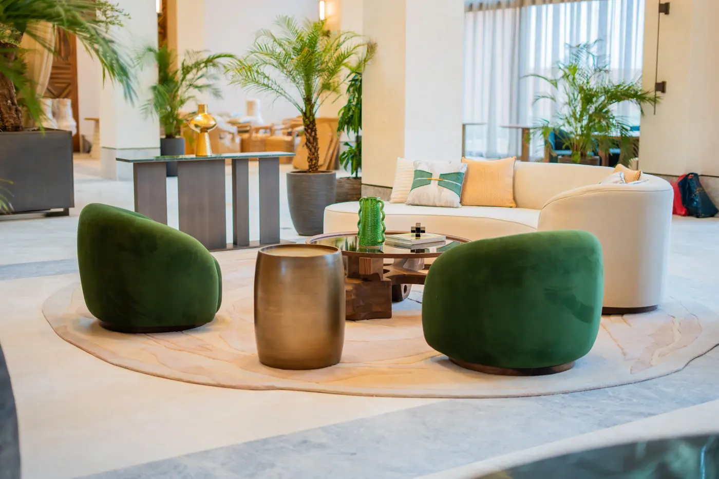 Velvet lounge chairs around a walnut table